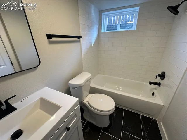 a bathroom with a sink a toilet and bathtub