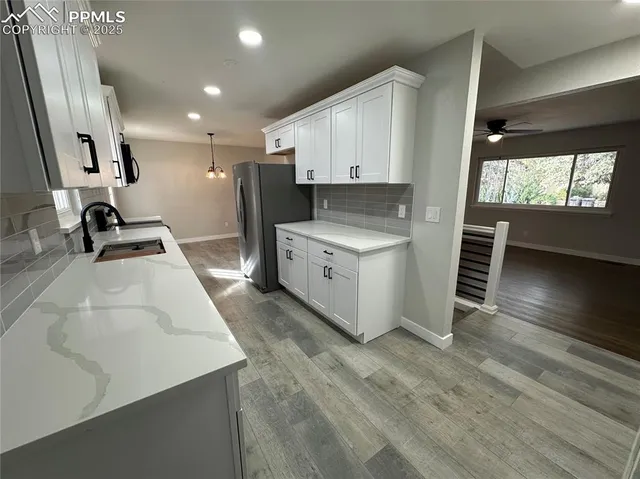 a kitchen with a sink a stove and a refrigerator