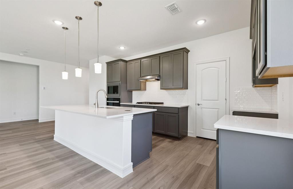 444 Avian Way Godley, TX 76044 - Photo 7 of 22 Spacious kitchen with pendant lighting