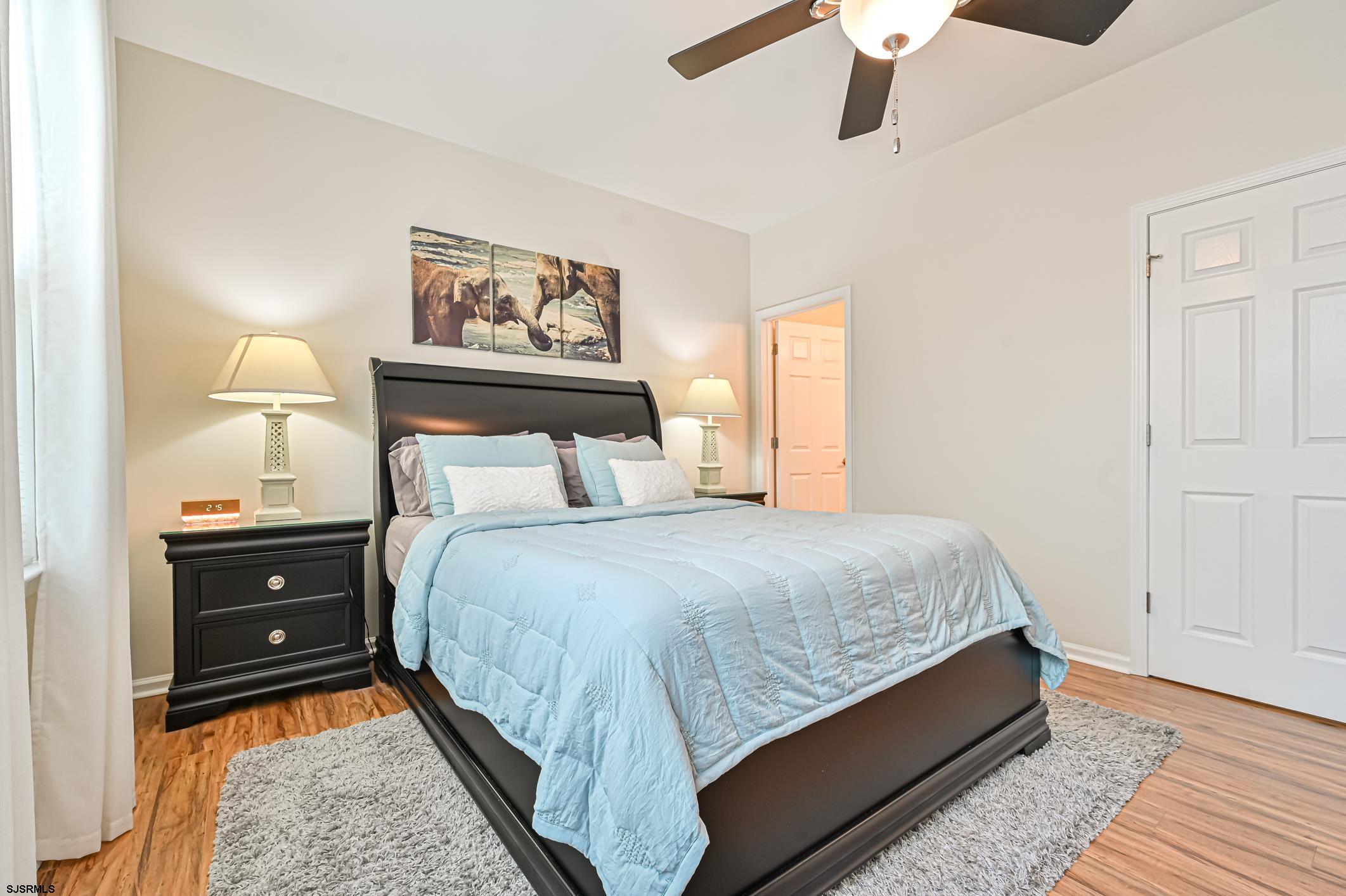 27 Ables Run Drive Absecon, NJ 08201 - Photo 14 of 28 a bedroom with a bed and painting on the wall