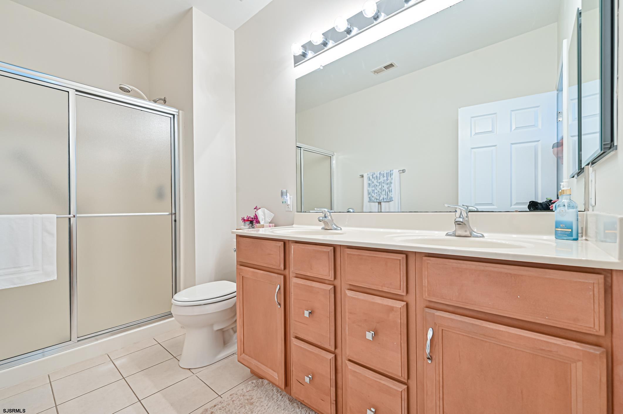 27 Ables Run Drive Absecon, NJ 08201 - Photo 17 of 28 a bathroom with a double vanity sink a toilet and a mirror