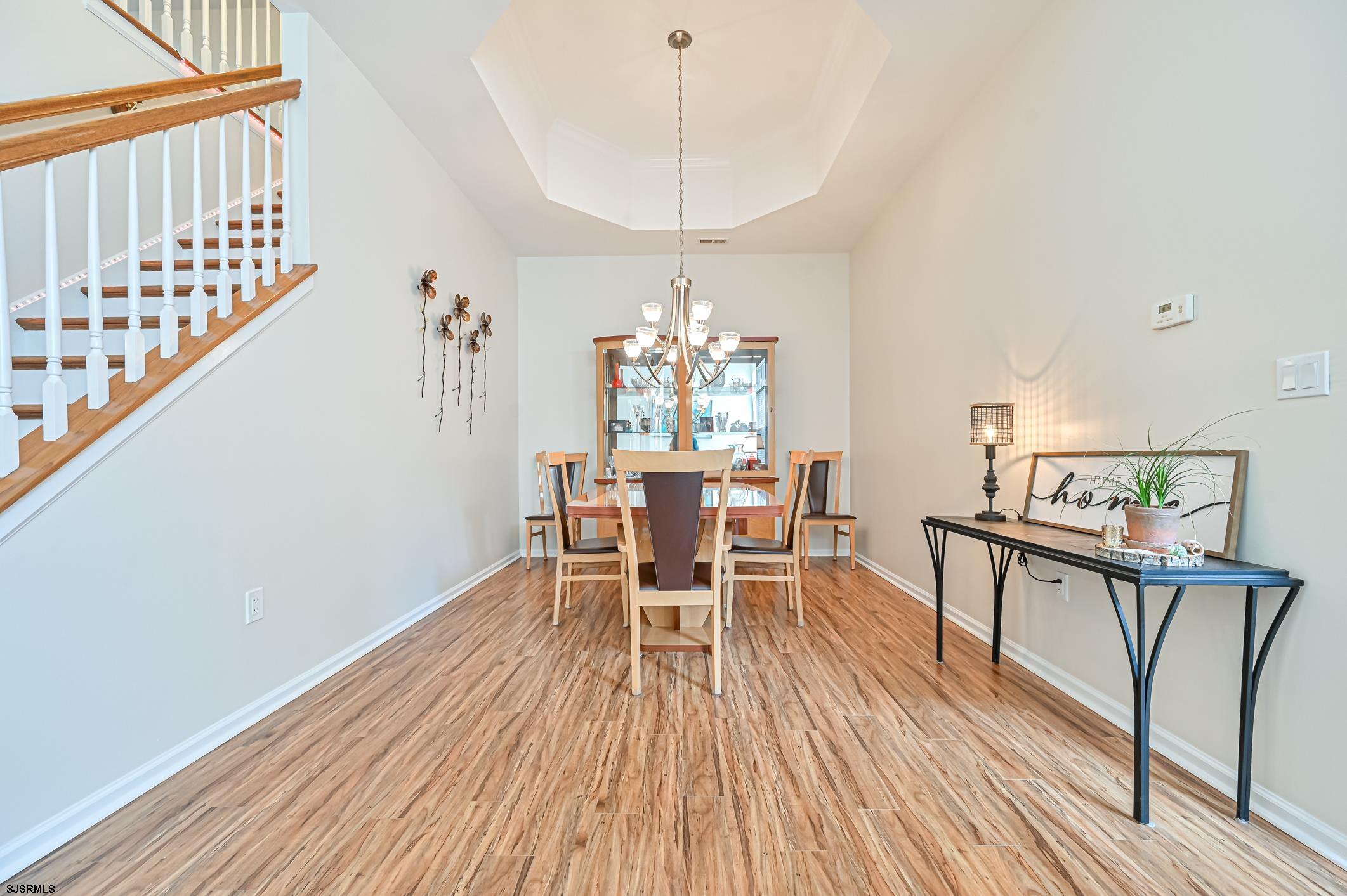 27 Ables Run Drive Absecon, NJ 08201 - Photo 9 of 28 a dining room with furniture a chandelier and wooden floor