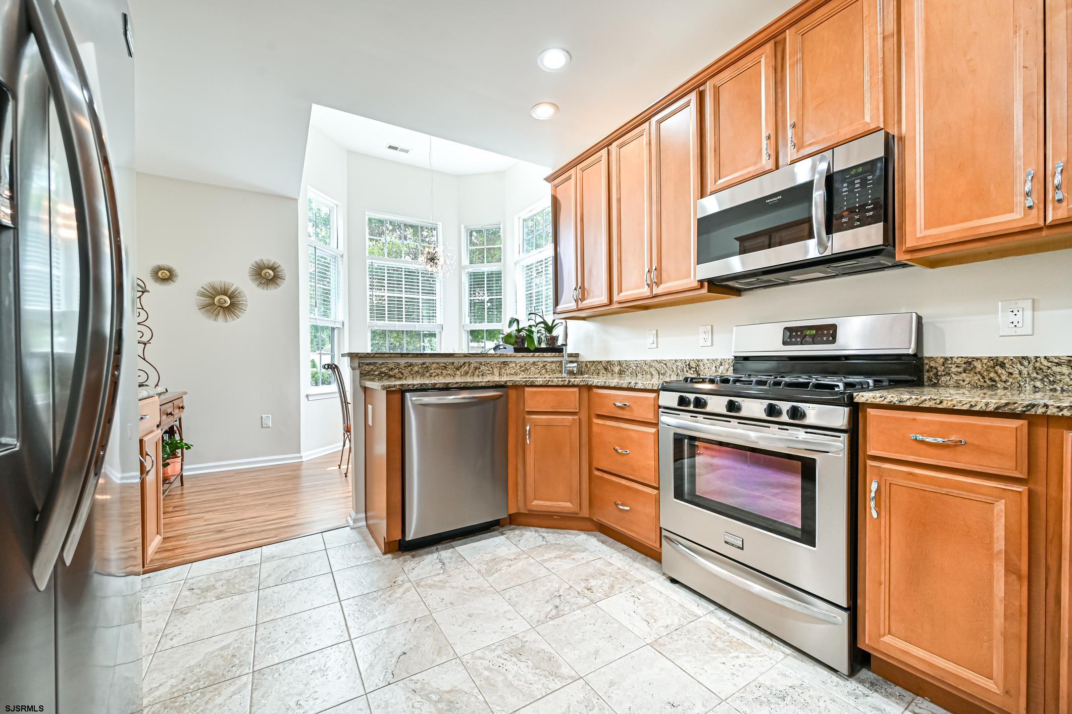 27 Ables Run Drive Absecon, NJ 08201 - Photo 10 of 28 a kitchen with stainless steel appliances granite countertop a stove a sink and a microwave