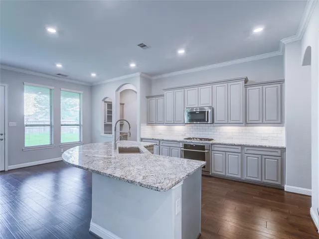 a view of a kitchen cabinets and wooden floor