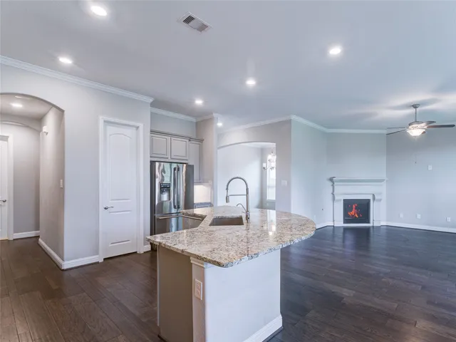a large kitchen with a lot of counter space and stainless steel appliances
