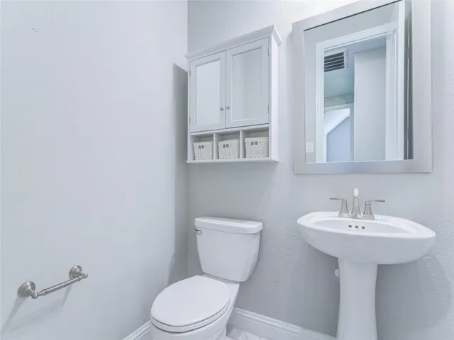 an empty room with closet and a chandelier fan