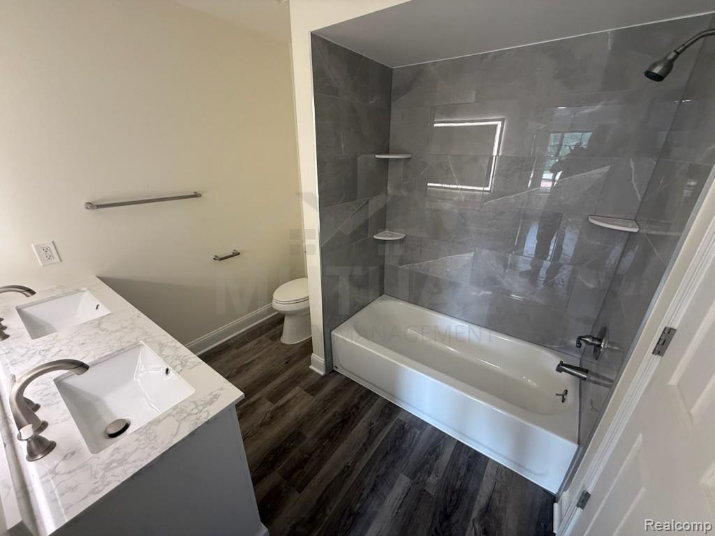 1560 Meadowside Drive Rochester, MI 48307 - Photo 11 of 17 Dual vanity with integrated sinks and a white stone-finish countertop