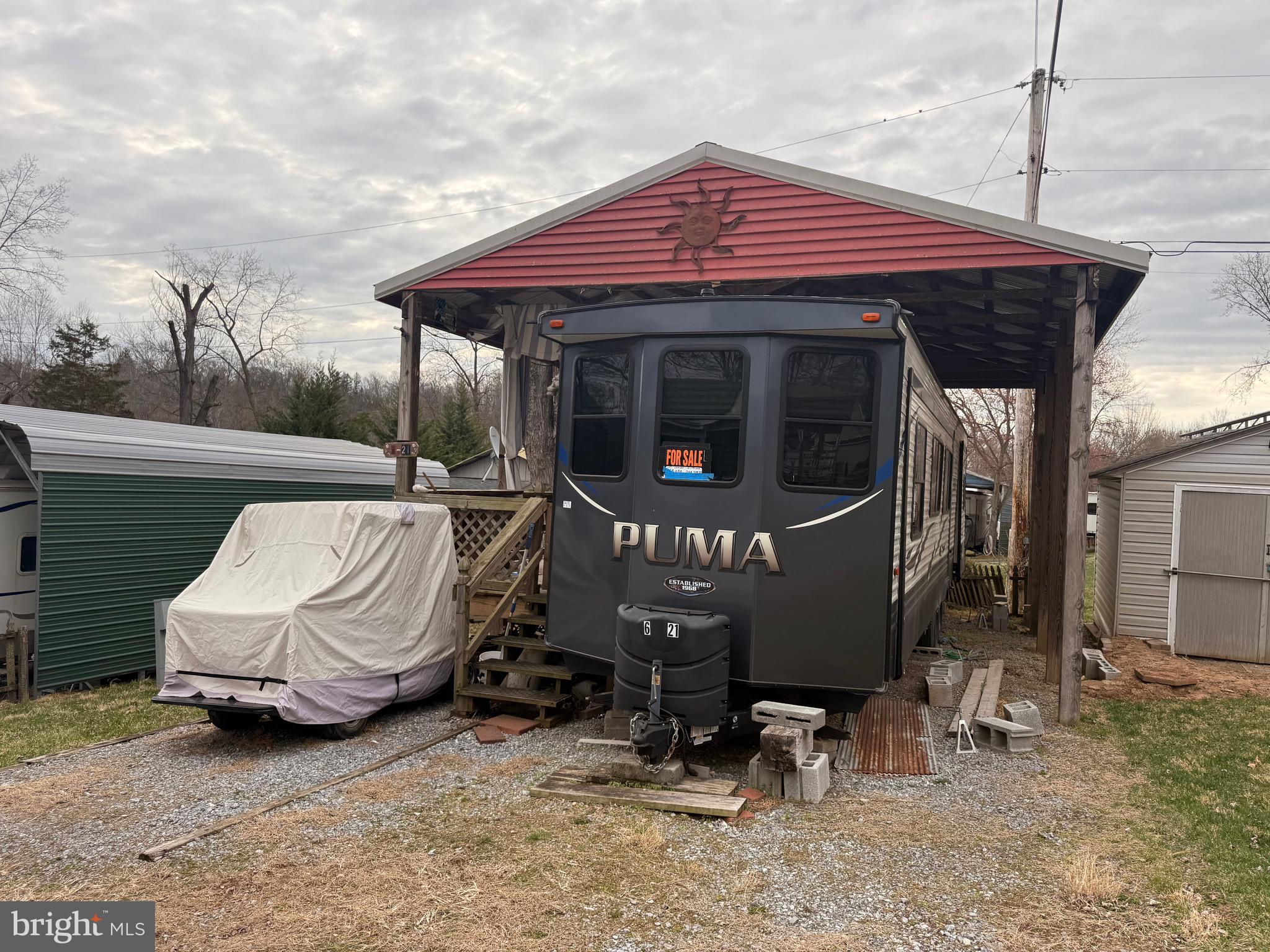 6 Block Yogi Bear Lane Falling Waters, WV 25419 - Photo 1 of 8 a front view of a house with sitting area