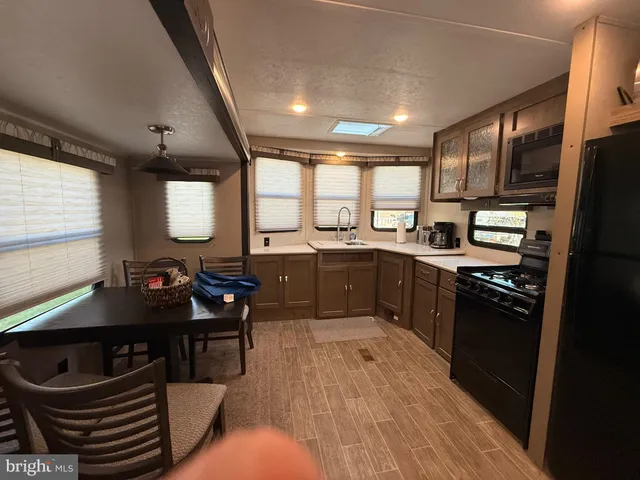 a kitchen with lots of counter furniture a sink and appliances