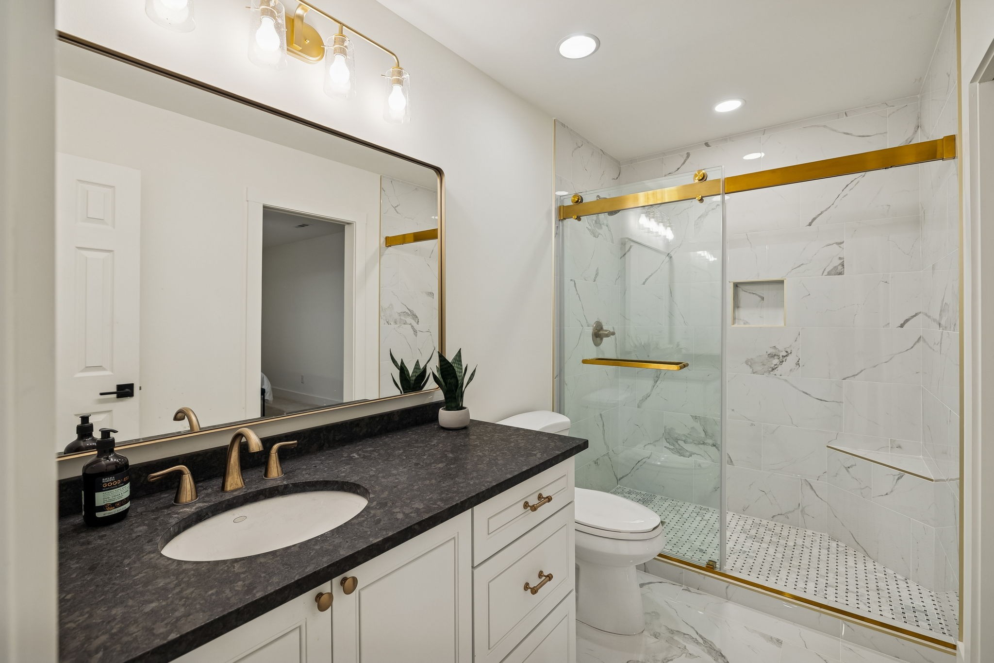 670 North Ridge Road Columbia, TN 38401 - Photo 27 of 45 a bathroom with a granite countertop sink a toilet a mirror and shower