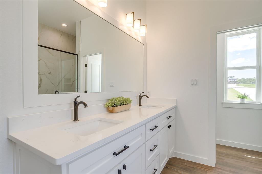 9012 Valley Oak Court Springtown, TX 76082 - Photo 31 of 40 a bathroom with a double vanity sink and mirror