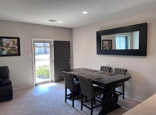 a view of a dining room with furniture and window