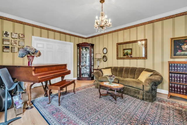 a living room with furniture and a chandelier