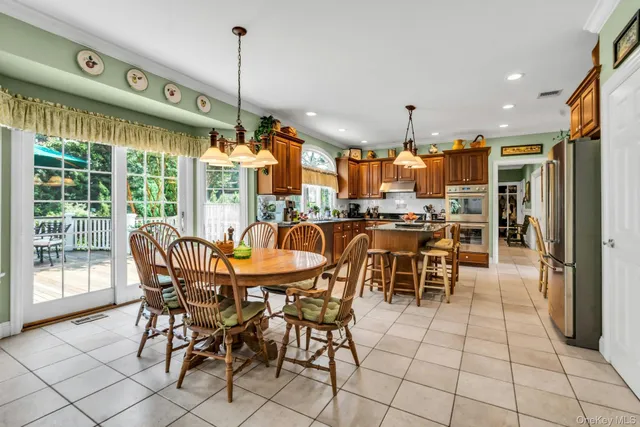 a dining area with furniture and a floor to ceiling window