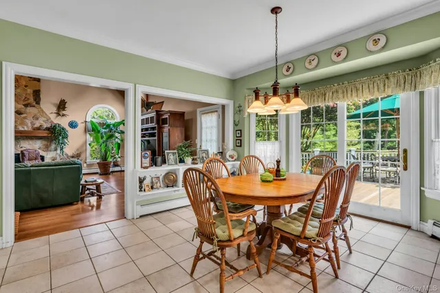 a dining room with furniture a chandelier and window