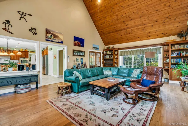 a living room with furniture rug and wooden floor