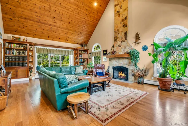 a living room with furniture a fireplace and potted plants