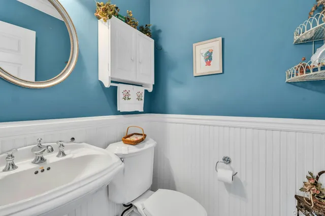 a bathroom with a sink mirror and toilet