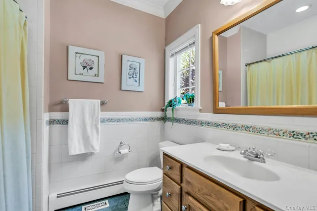 a bathroom with a sink toilet and window