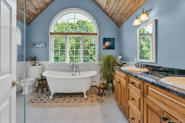 a spacious bathroom with a granite countertop tub and a sink