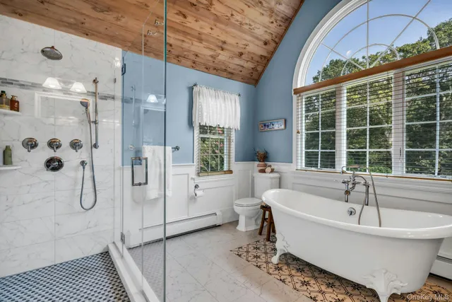 a white bath tub sitting next to a white toilet