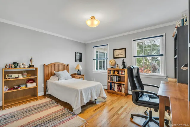 a bedroom with a bed and a bookshelf