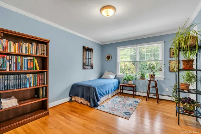 a bedroom with furniture and a window