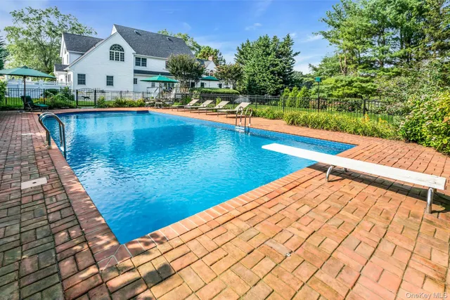 a view of a house with swimming pool and sitting area