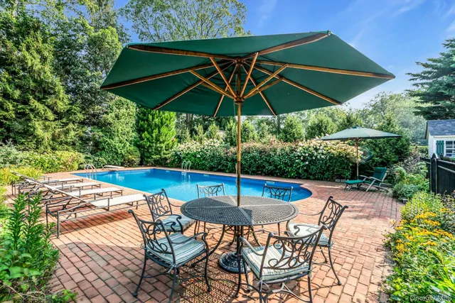a view of an outdoor sitting area with furniture and umbrella