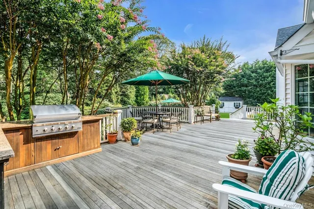 a view of a deck with chairs and wooden floor