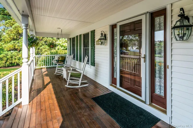 a view of a chairs and table in a balcony