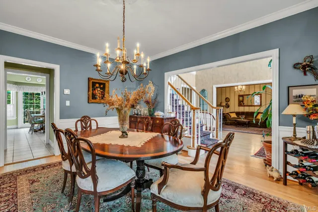 a view of a dining room with furniture and a chandelier