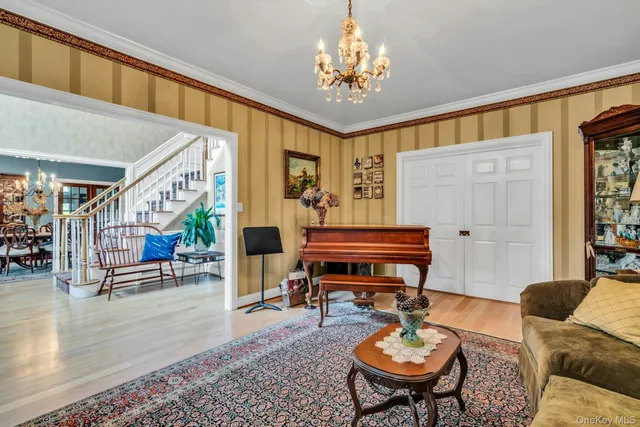 a living room with furniture a piano and a table