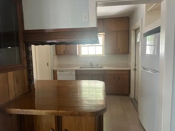 a kitchen with stainless steel appliances a refrigerator and a sink