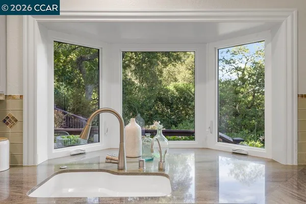 a kitchen with a sink and large window