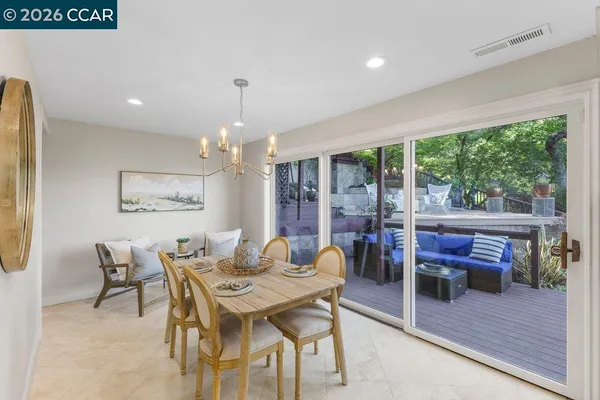 a dining room with furniture a rug and wooden floor