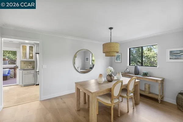 a dining room with a wooden table and chairs