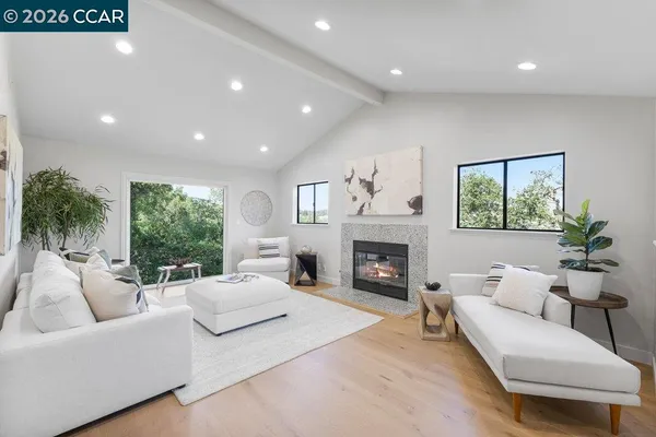 a living room with furniture a fireplace and a window