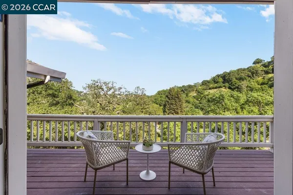 a view of a chair and table in the balcony