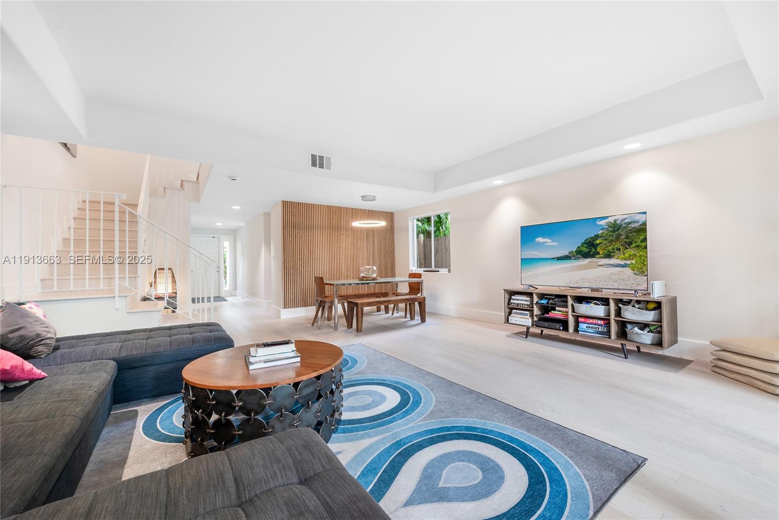 3124 Jackson Avenue, Unit 1 Miami, FL 33133 - Photo 11 of 23 a living room with furniture and a table