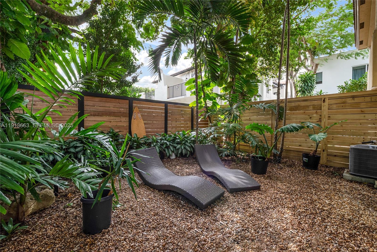 3124 Jackson Avenue, Unit 1 Miami, FL 33133 - Photo 12 of 23 a view of a backyard with plants and a patio