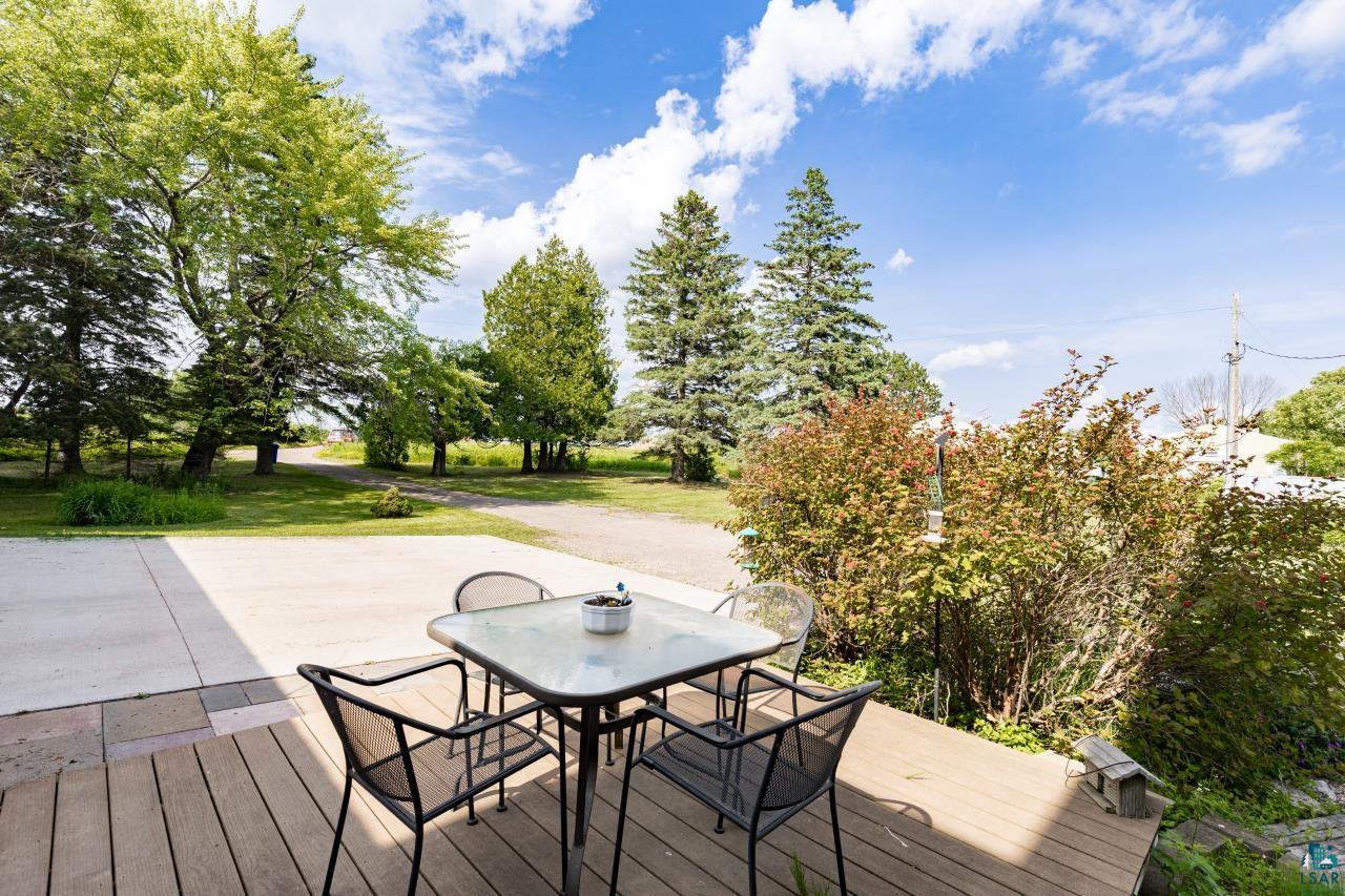4800 Tower Road Moose Lake, MN 55767 - Photo 26 of 83 Expansive outdoor deck with wood-finish flooring, complemented by a concrete patio