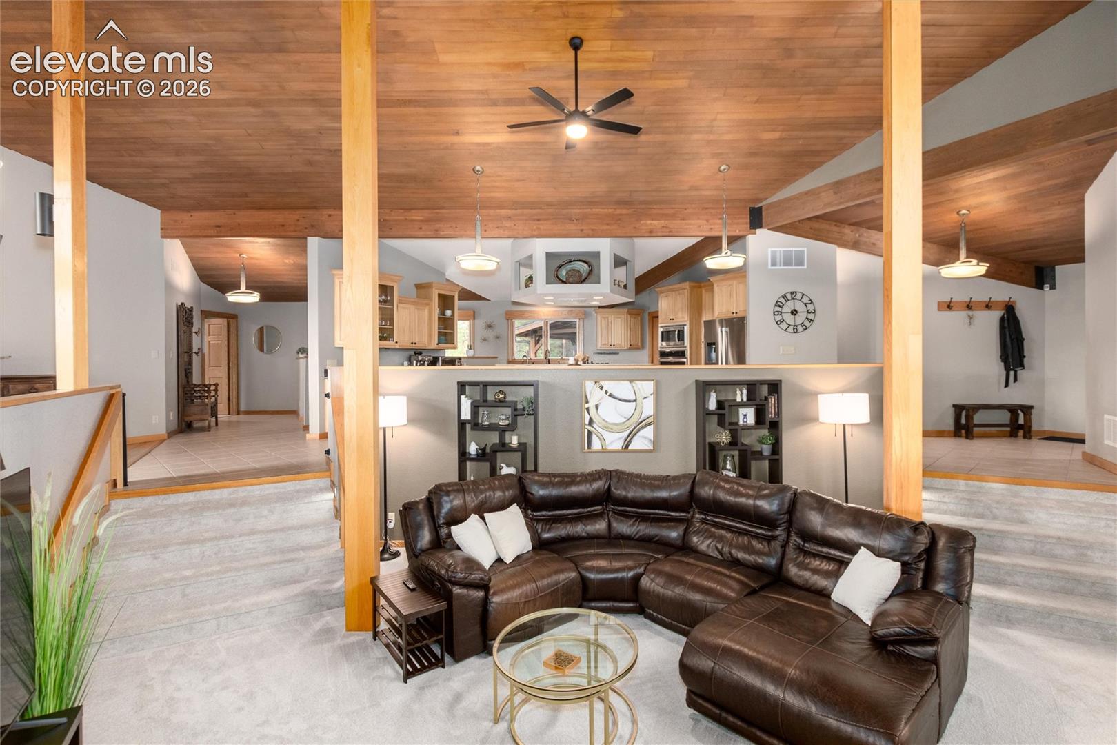 12730 Bridle Bit Road Colorado Springs, CO 80908 - Photo 8 of 48 Vaulted wood-finish ceilings with exposed beams and ceiling fans
