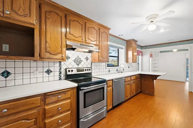 a kitchen with stainless steel appliances granite countertop a stove and a sink