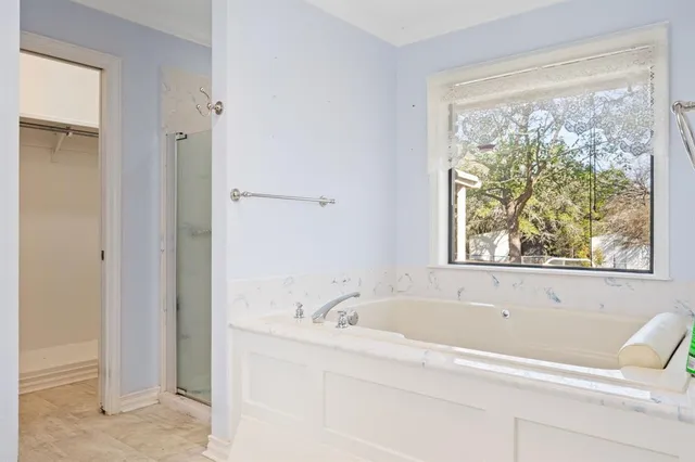 a white bath tub sitting next to a window