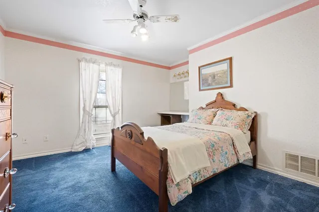 a bedroom with bed and window