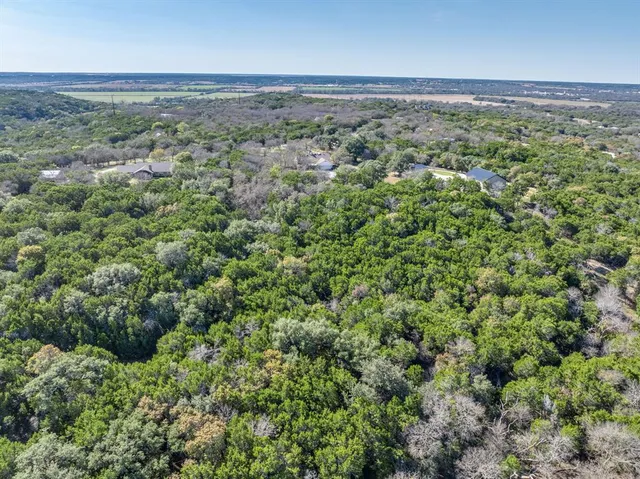 an aerial view of a houses with a yard