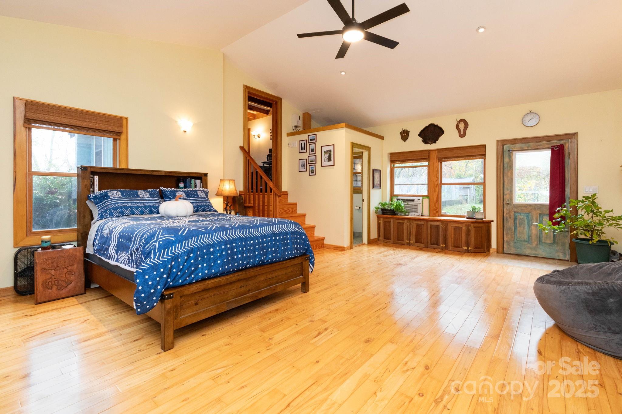 35 Norton Br Road Marshall, NC 28753 - Photo 16 of 35 a bedroom with a large bed and a chandelier