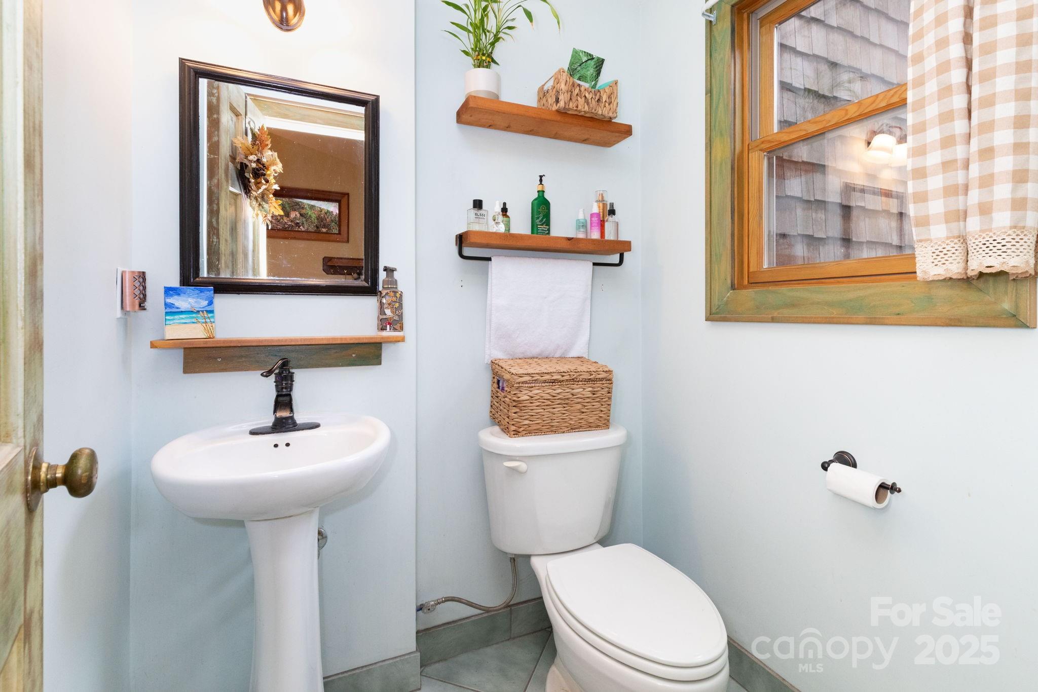 35 Norton Br Road Marshall, NC 28753 - Photo 21 of 35 a bathroom with a toilet sink and mirror