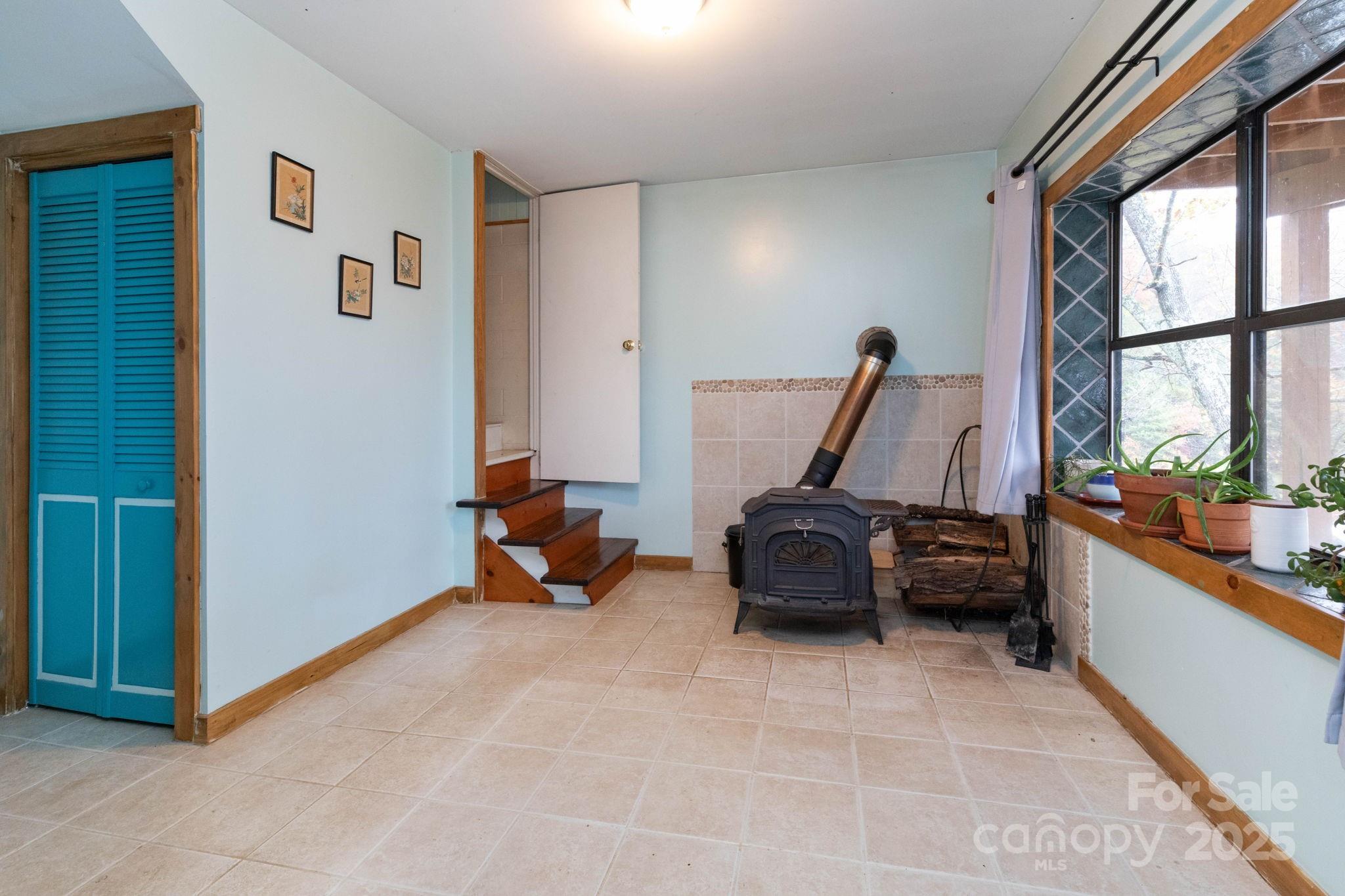 35 Norton Br Road Marshall, NC 28753 - Photo 24 of 35 a living room with furniture gym equipment and a large window